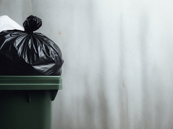 waste management bins filled with trashbags