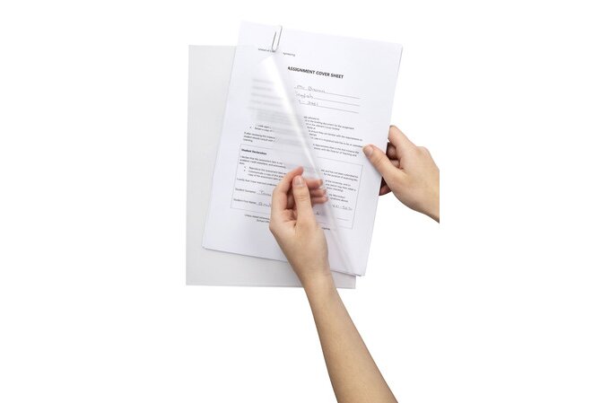 A pair of hands holding a clear, transparent document cover over printed white paper forms against a solid white background.